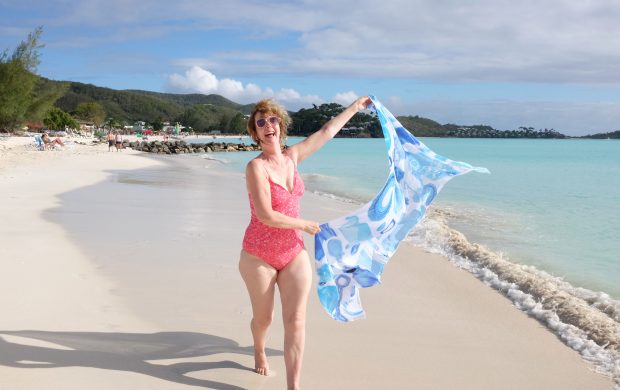 Happy Sarong lady running on Jolly Harbour beach Antigua
